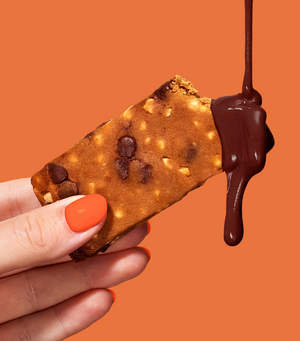 Image of chocolate dripping over a peanut butter chocolate crunch MOSH bar