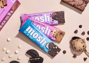 Image of 3 MOSH bars fanned out including the Chocolate Brownie Crunch, Cookie Dough Crunch and Cookies and Cream Crunch flavors