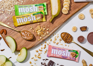 Image of the Banana Bread and Apple Cinnamon Oatmeal flavored MOSH bars over ingredients of these bars