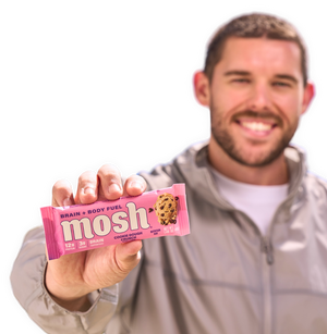 Male holding MOSH protein bar in a wrapper featuring brain-boosting ingredients